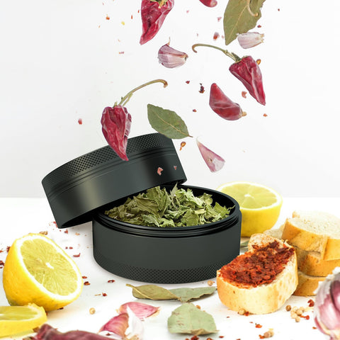SKROM MYP grinder in use with pepper and other spices in a kitchen