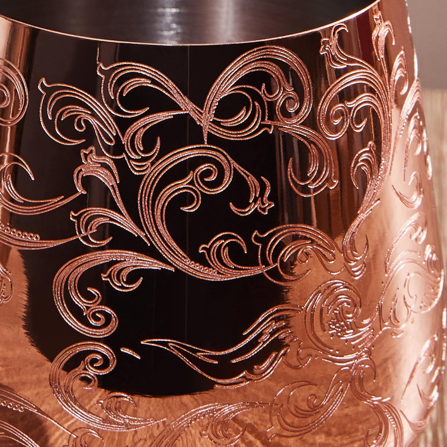 Sky Fish wine goblets copper-rim close-up shows baroque engraving and warm detail.