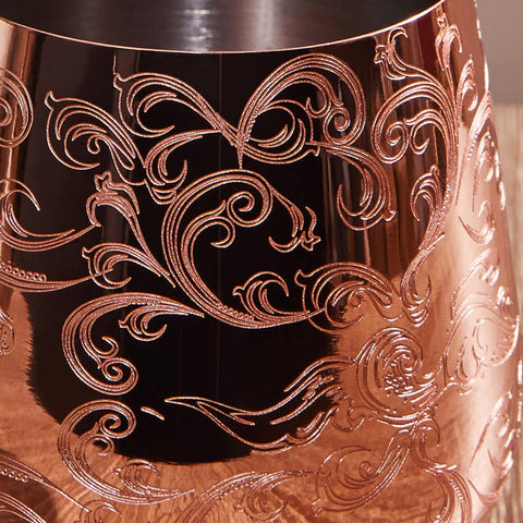 Sky Fish wine goblets copper-rim close-up shows baroque engraving and warm detail.
