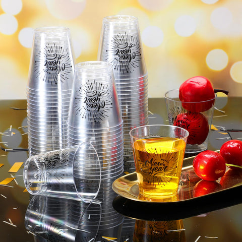 Sliner clear plastic shot glasses with New Year design for easy serving.