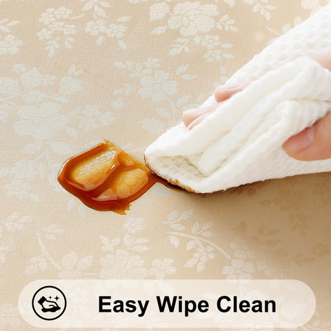 Smiry wipeable beige tablecloth being wiped clean after a casual meal