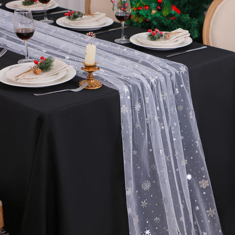 Snowkingdom snowflake table runner draped over a table for festive dining.