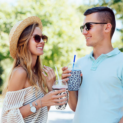 Snowso cow-print sleeve on desk as a stylish beverage accessory