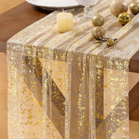 Socomi Christmas Snow Table Runner in gold gauze adds festive shine to holiday table settings.