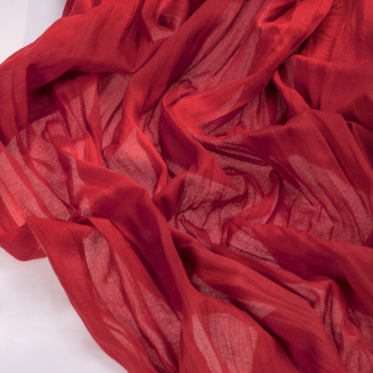 Socomi red cheesecloth table runner on dining table enhances romantic festive ambiance.