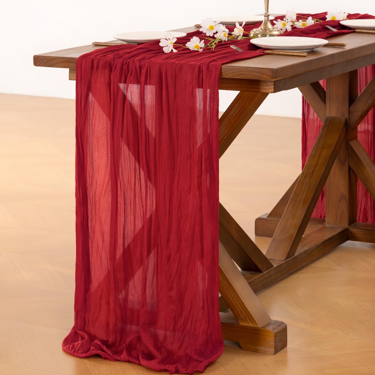 Socomi red cheesecloth table runner used for party decor.