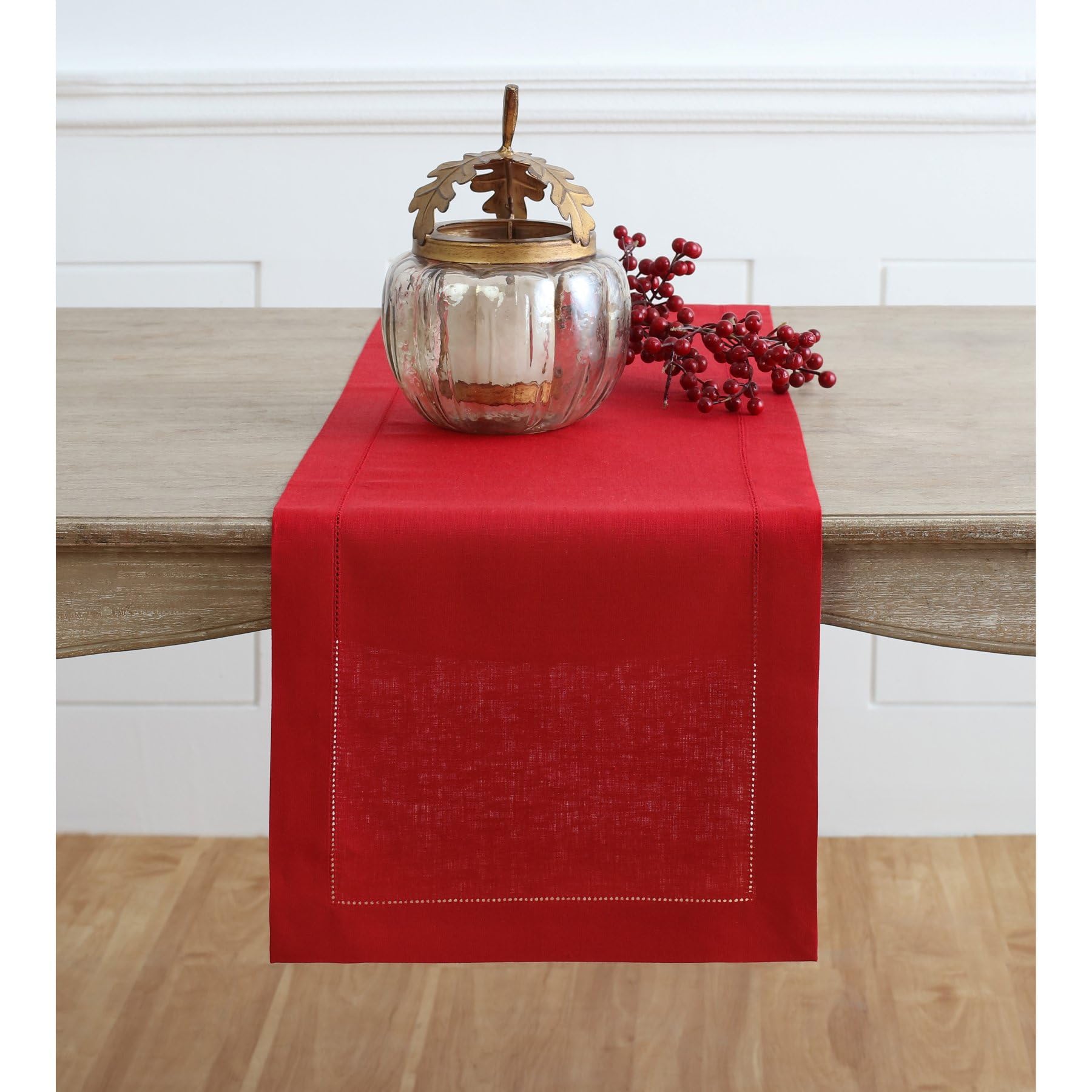 Solino Home red linen table runner with classic hemstitch on a dining table.