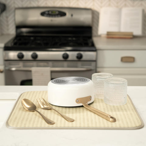 Mat under dish rack catches drips and protects countertops.