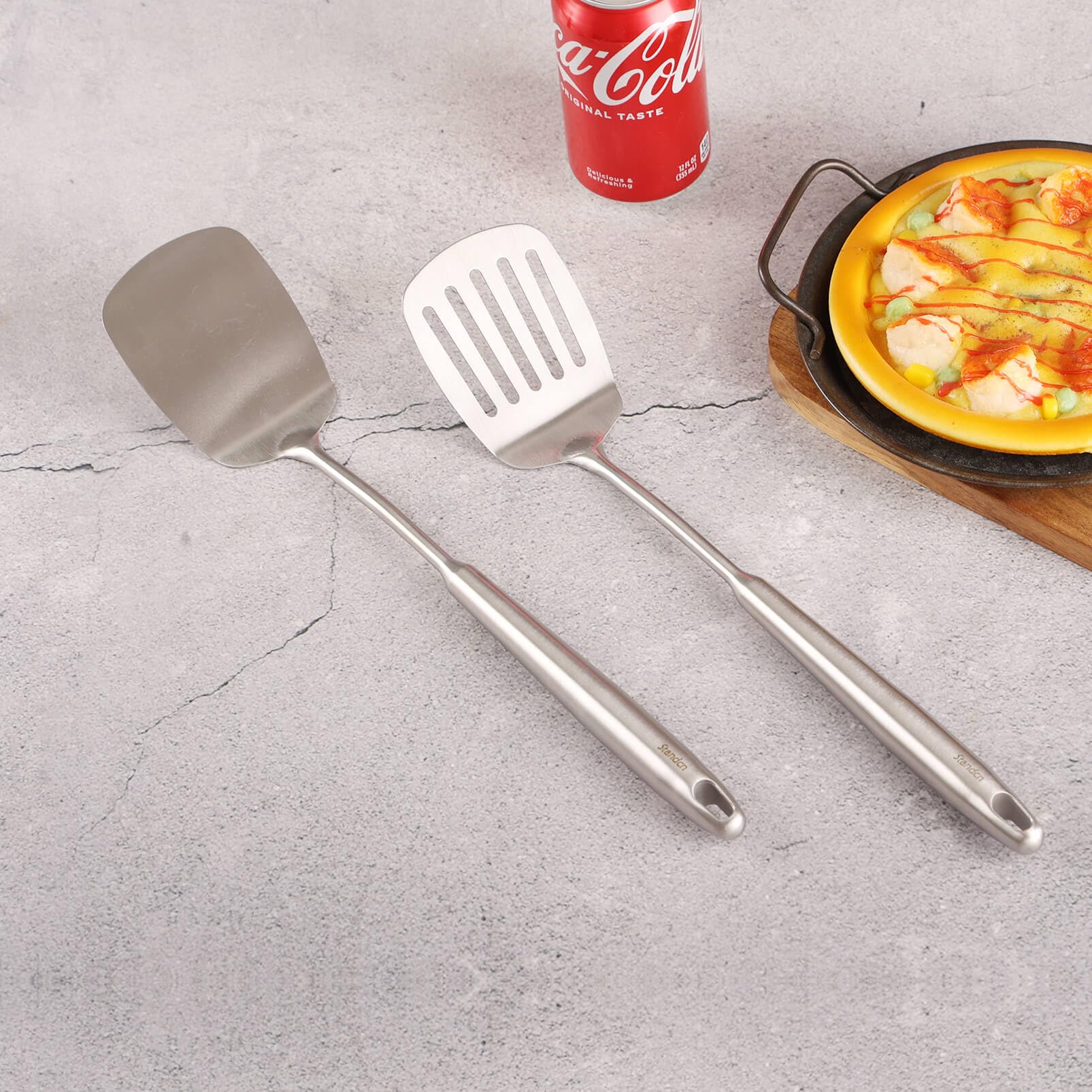 Standcn dishwasher-safe stainless spatula for easy cleanup after meals.