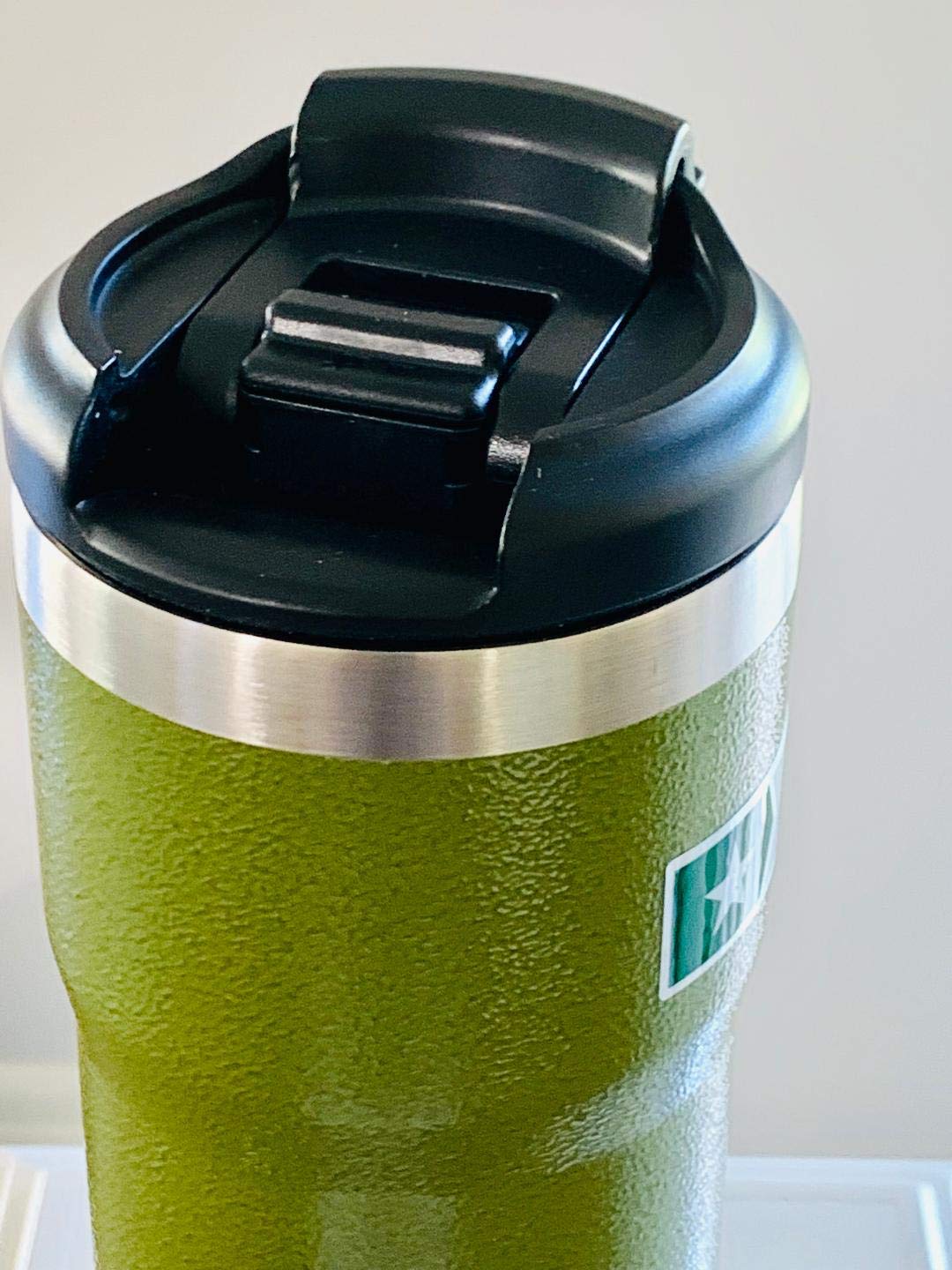 Starbucks x Stanley military green tumbler close-up showing durable steel and color.