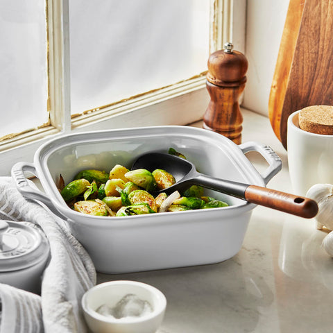 STAUB silicone spoon with acacia wood handle offers ergonomic grip.
