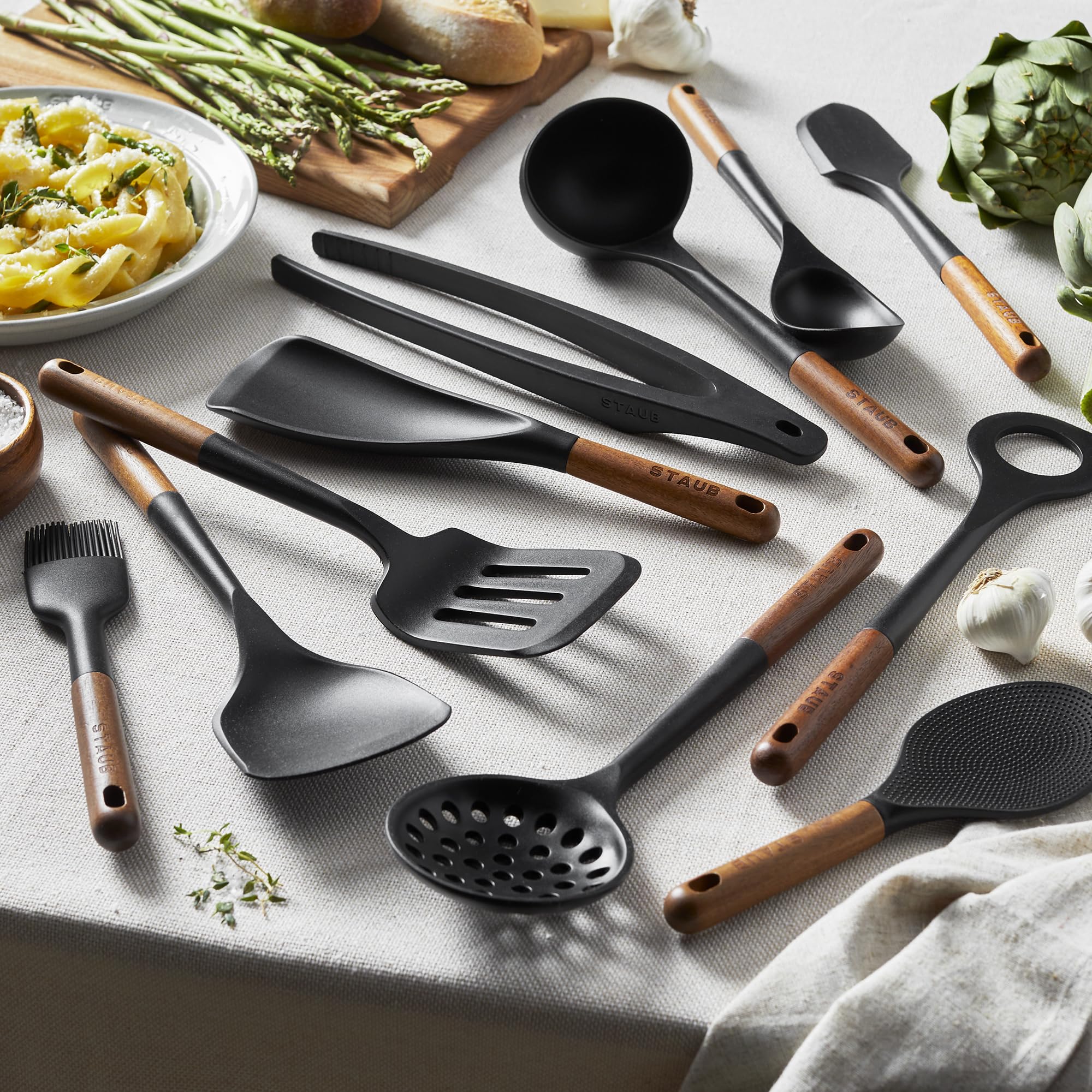 STAUB tongs offer precise turning and serving with durable silicone and wood grip.