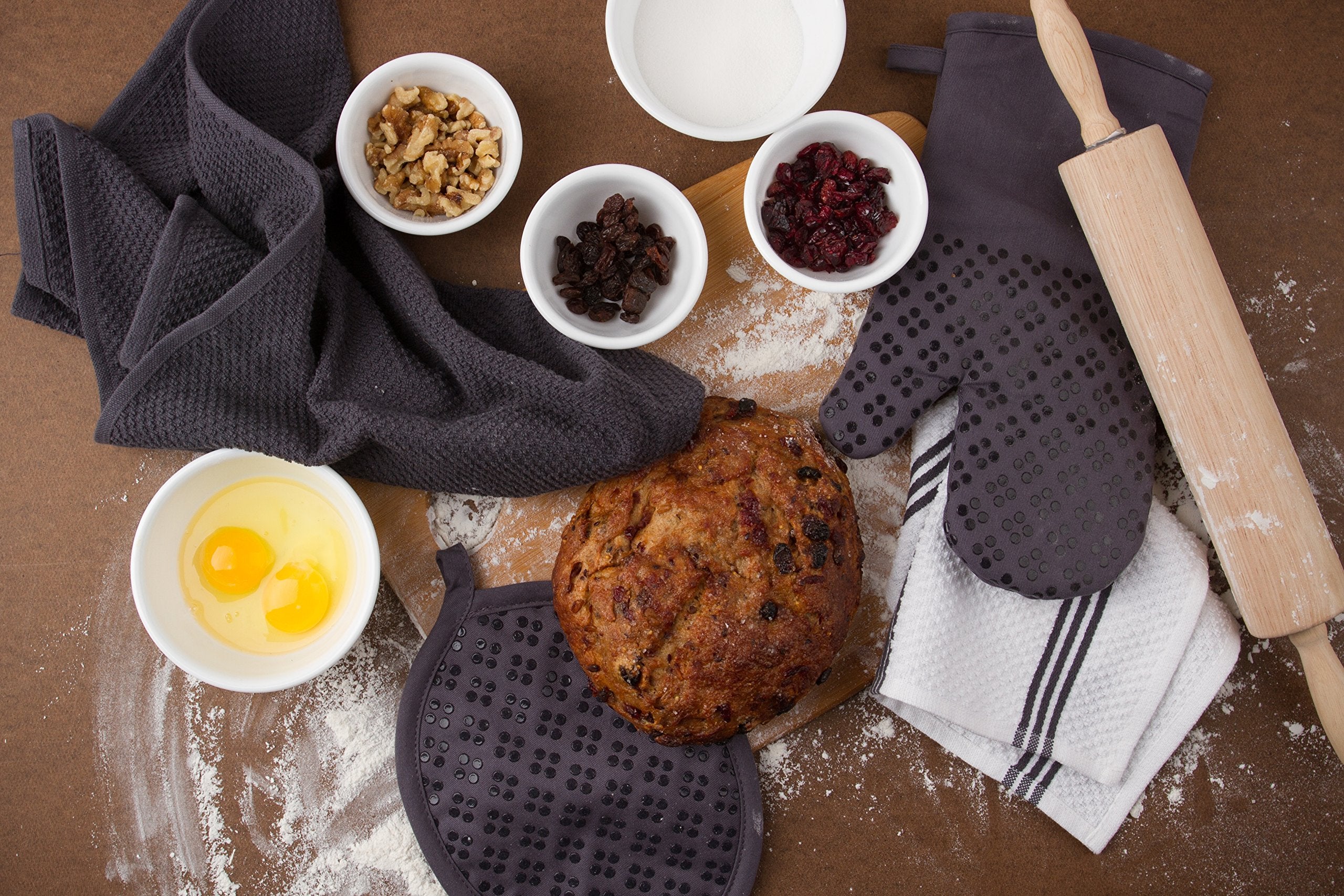 Sticky Toffee gray towels in use, wiping a spill with quick, absorbent performance.