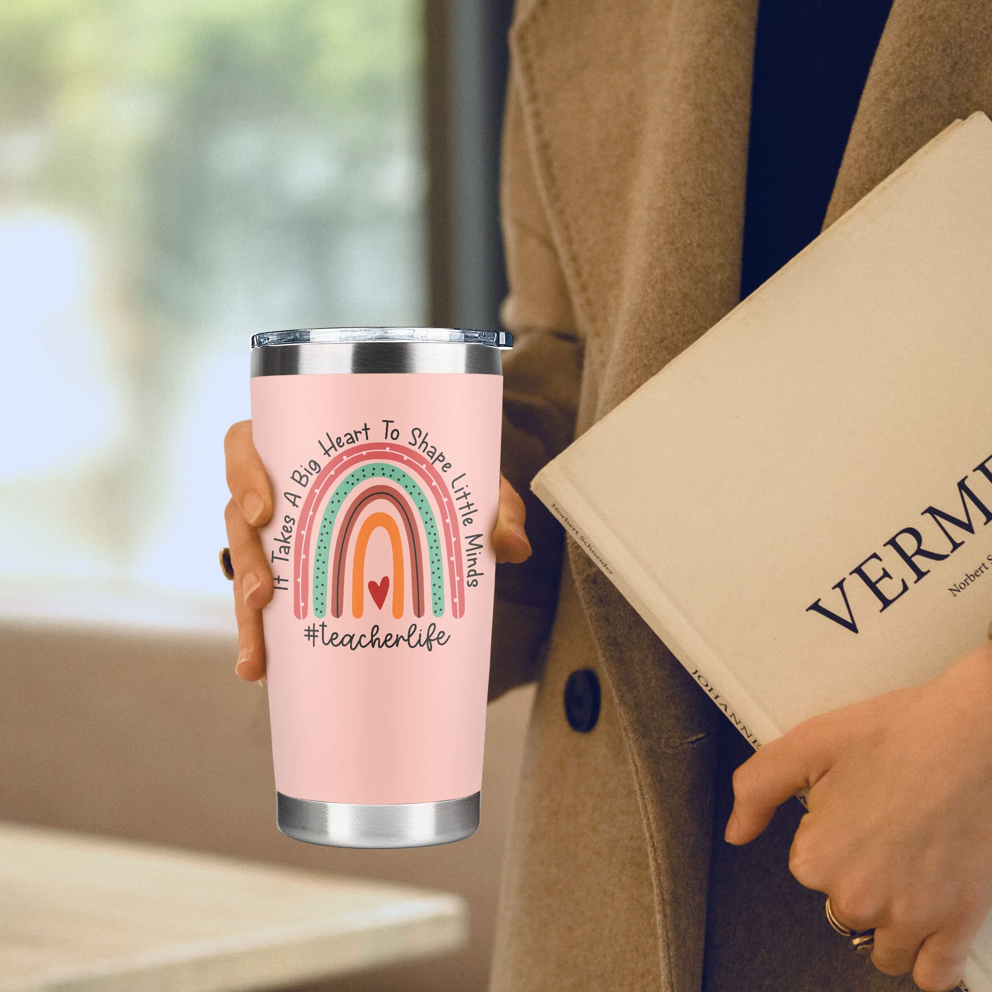 Suchagift pink 20oz tumbler held in hand during commute.