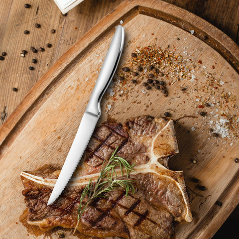 SuperCook serrated steak knife closeup on table showing table-ready edge