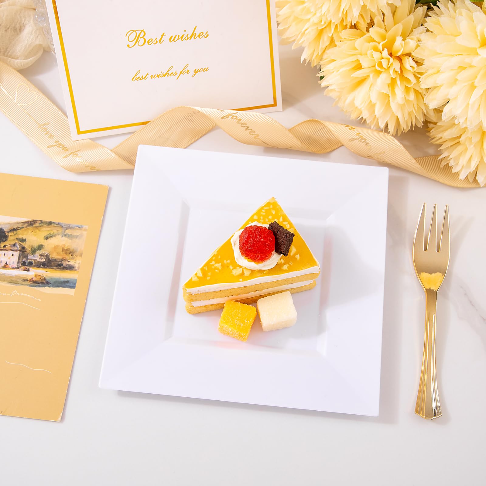 Close-up of Supernal gold plastic forks (5.7 inches) paired with white dessert plates