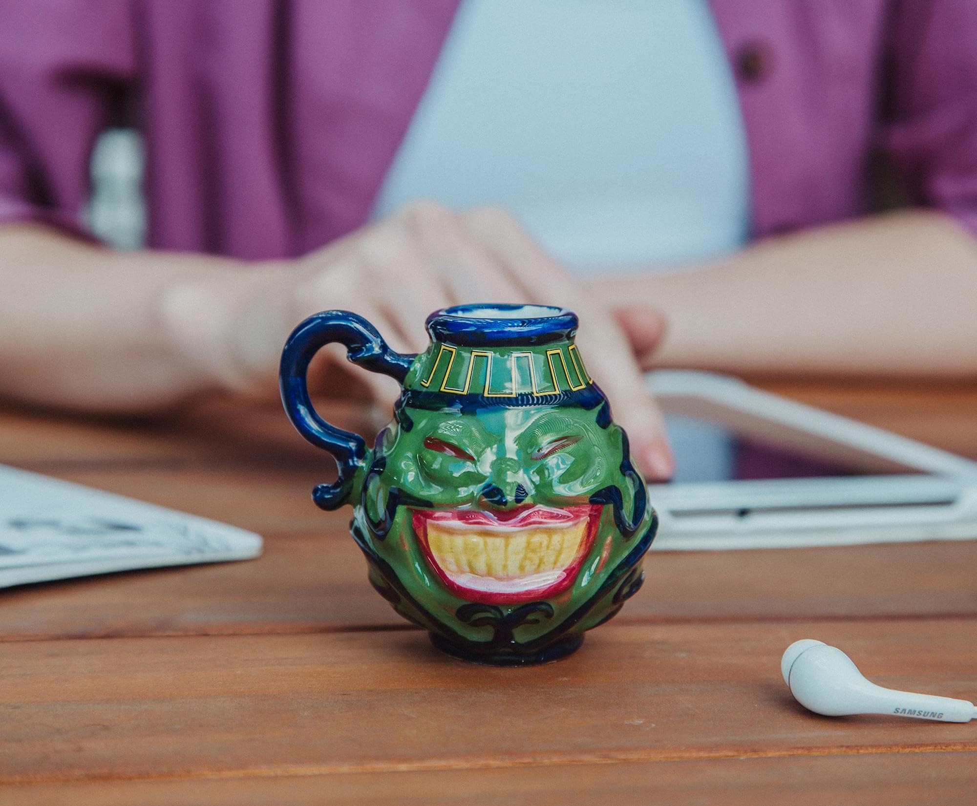 Surreal Entertainment Pot Of Greed mini mug on a desk beside a keyboard, ideal for dueling nights.