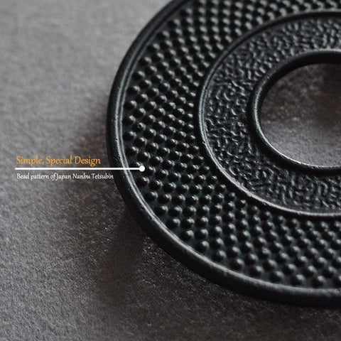 Suyika teapot trivet in black cast iron keeps kettle stable on stove.