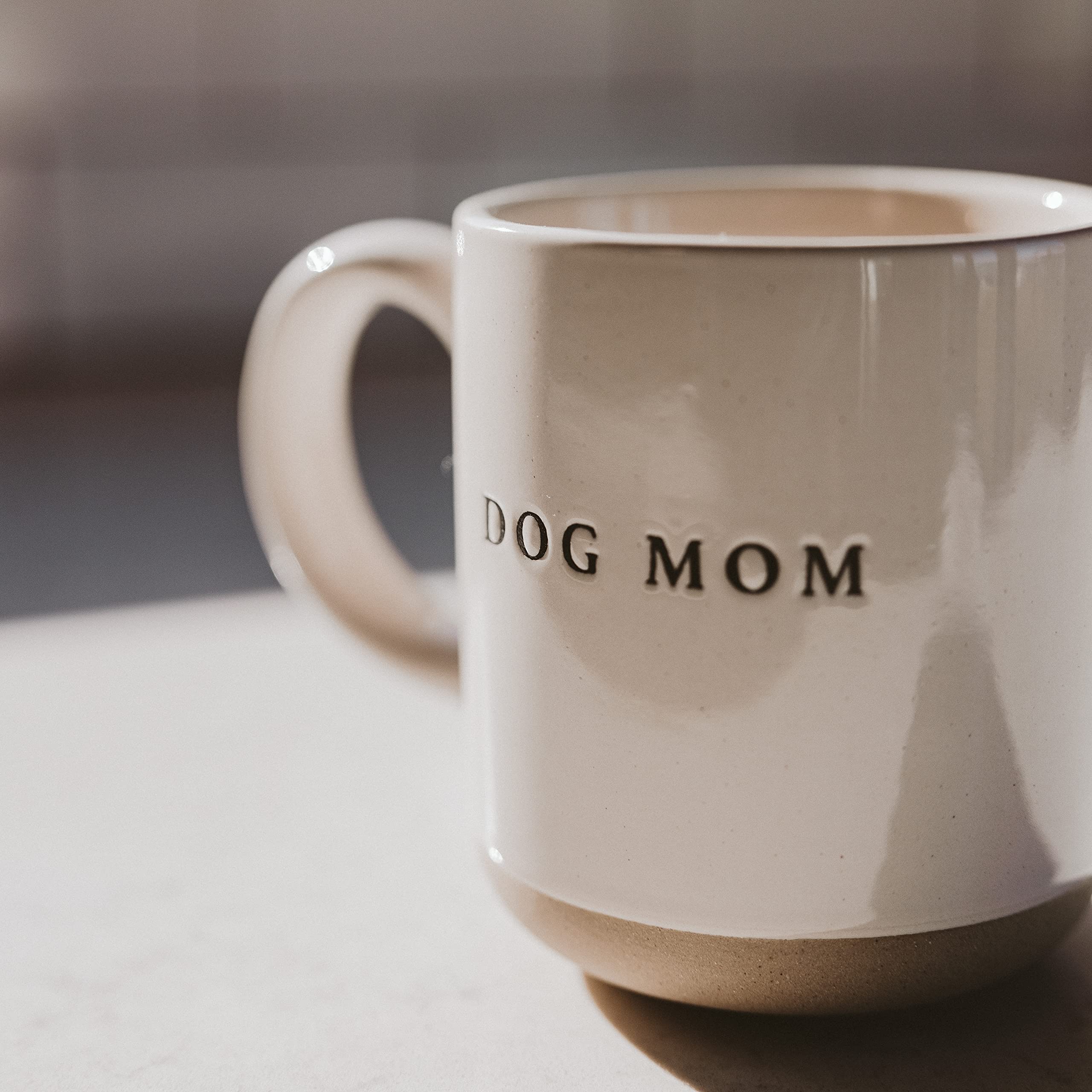 Sweet Water Decor Dog Mom mug in a kitchen, versatile for hot or cold drinks.