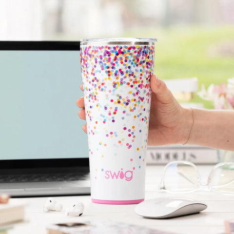 Swig Life 32oz tumbler demonstrates cup holder compatibility for travel.