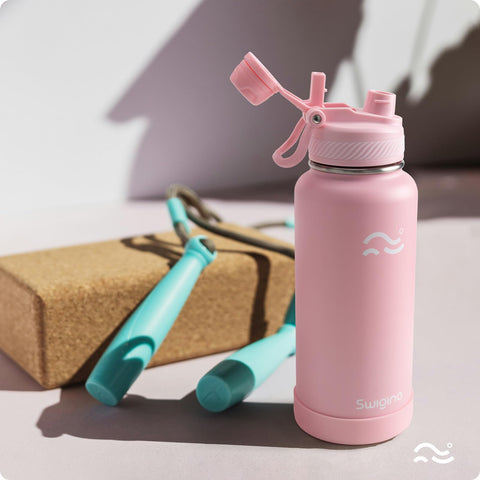 Swigina bottle shown in gym use with straw lid.