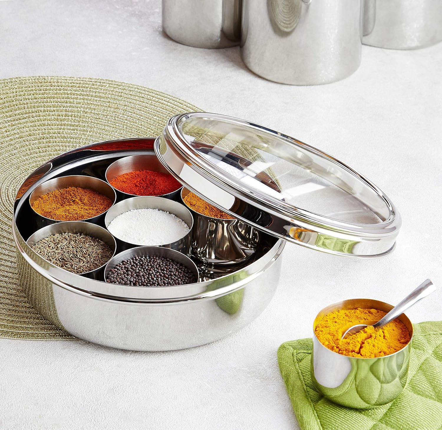Taluka stainless steel spice box with seven small containers for variety.