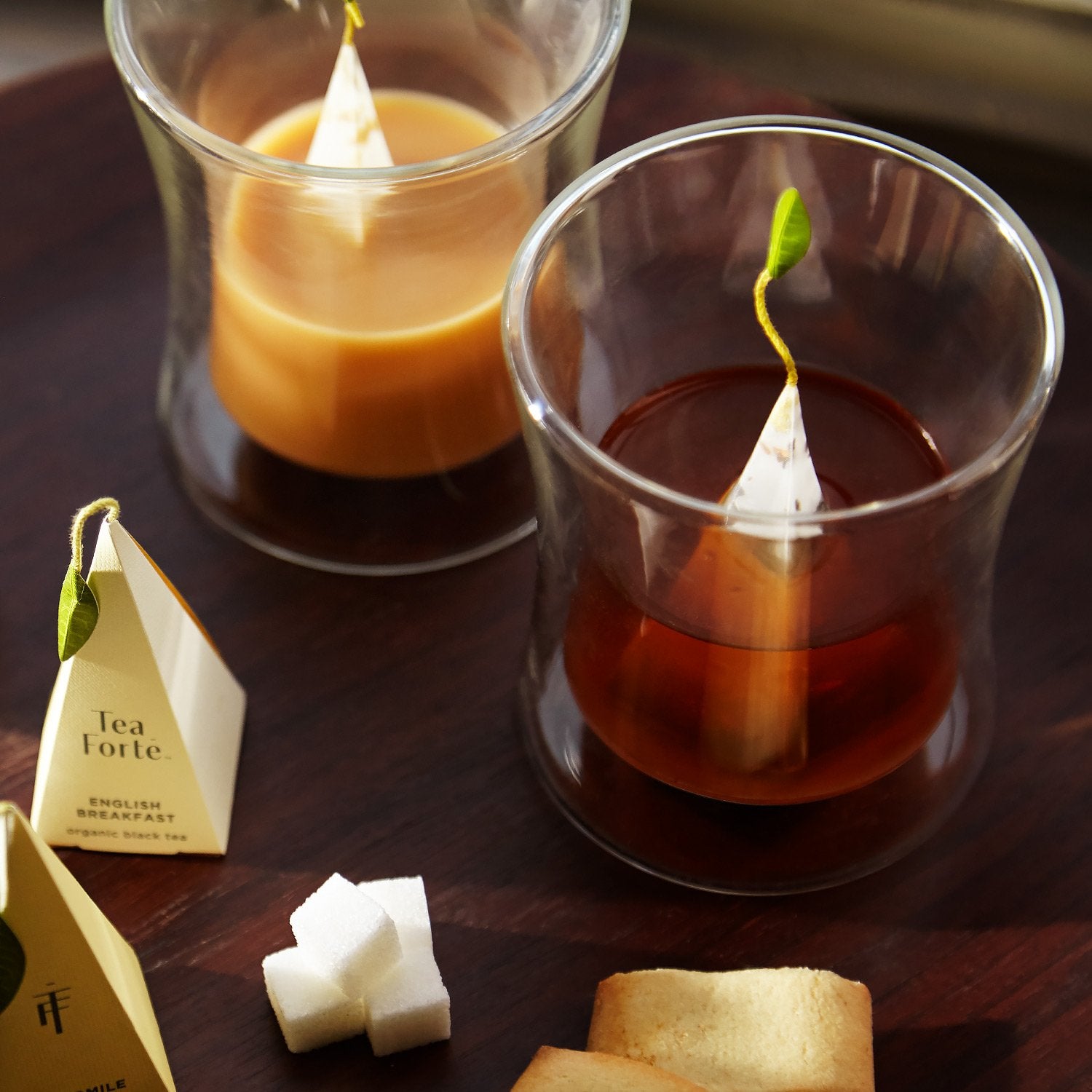 Tea Forte Poom infuser display showcases pyramid infusers with jewel-toned teas.