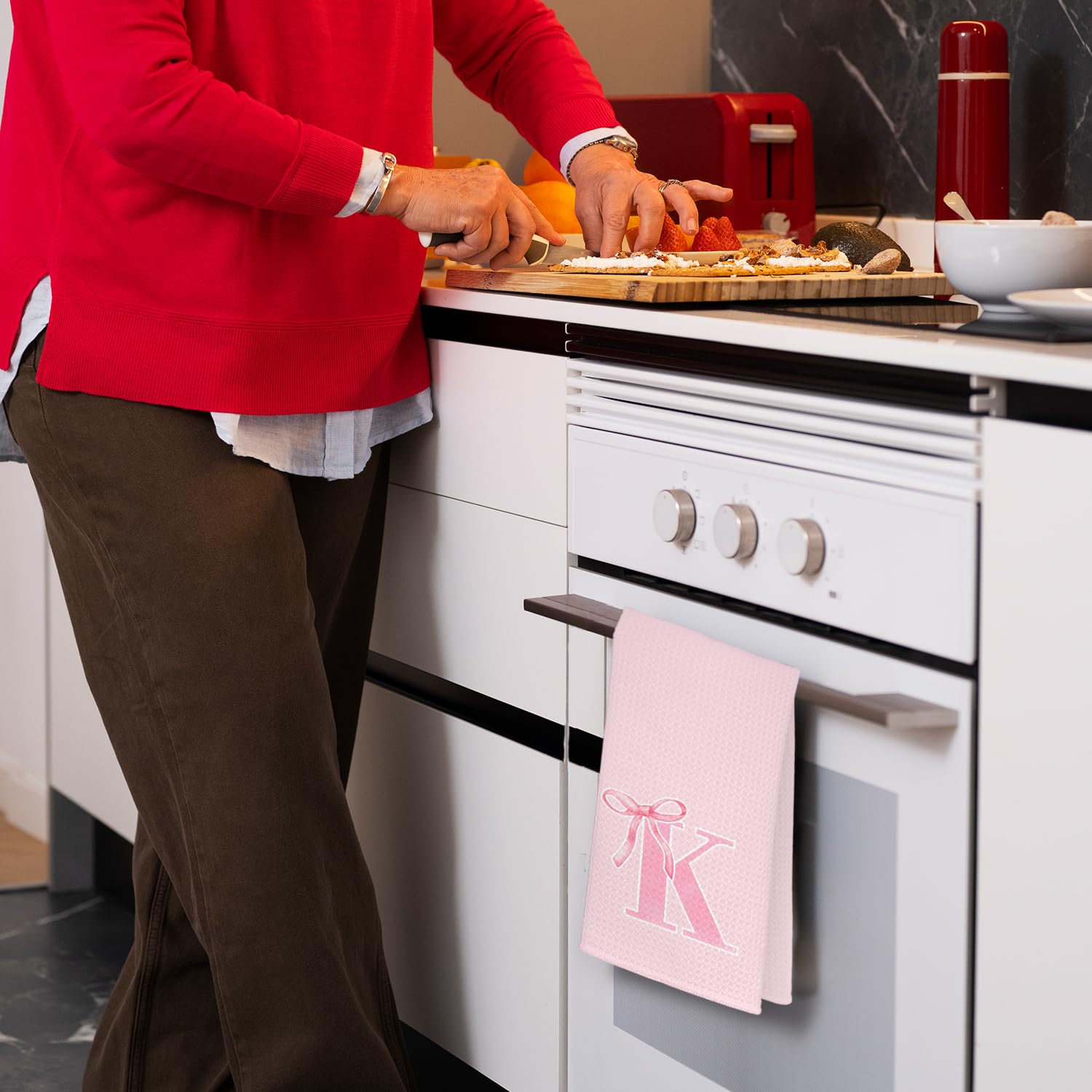 THDSE monogram towel with pink bow adds a charming decorative touch by the sink.