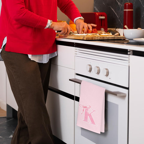 THDSE monogram towel with pink bow adds a charming decorative touch by the sink.