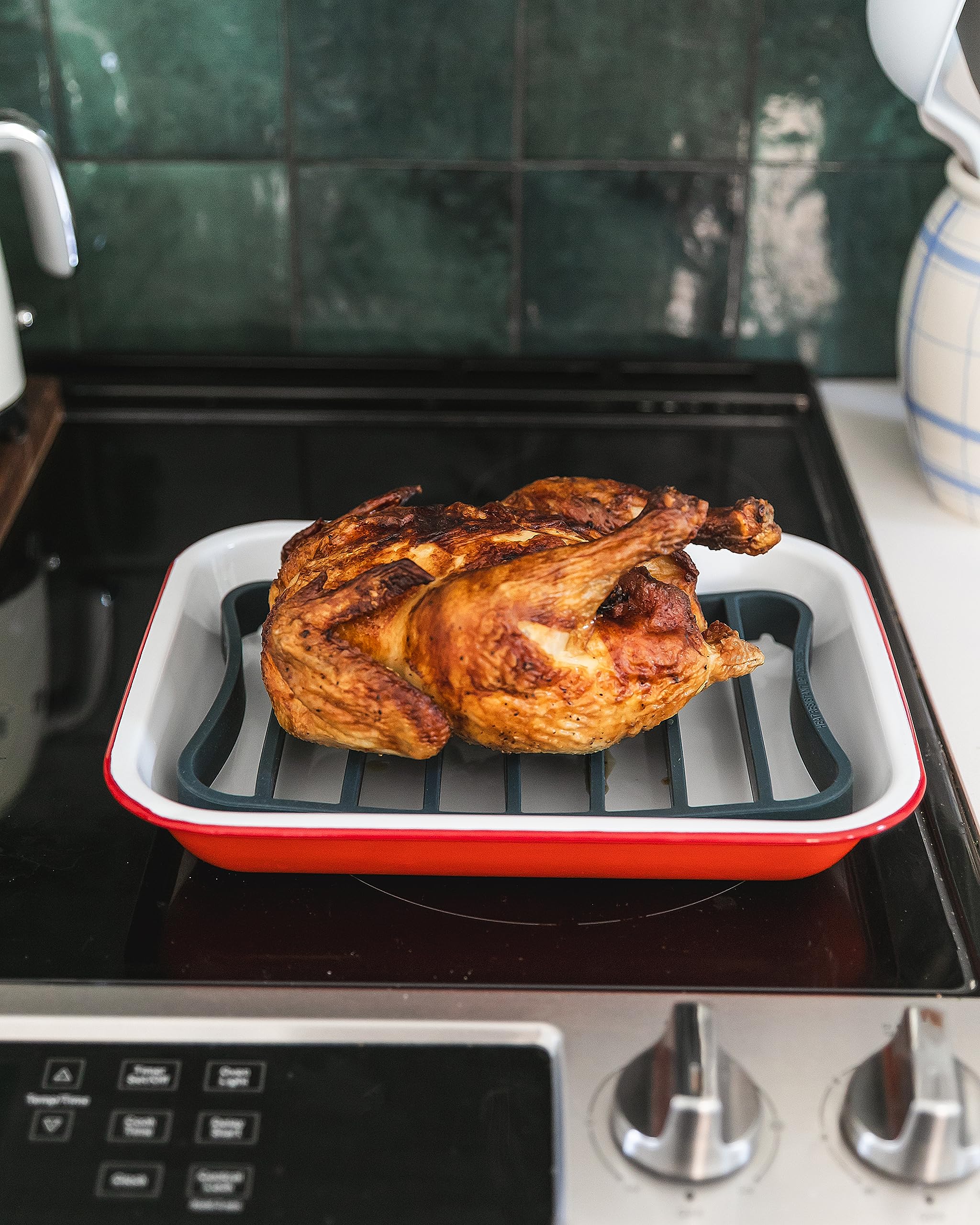 Two navy roasting racks on a half-sheet demonstrate versatile coverage for larger roasts.