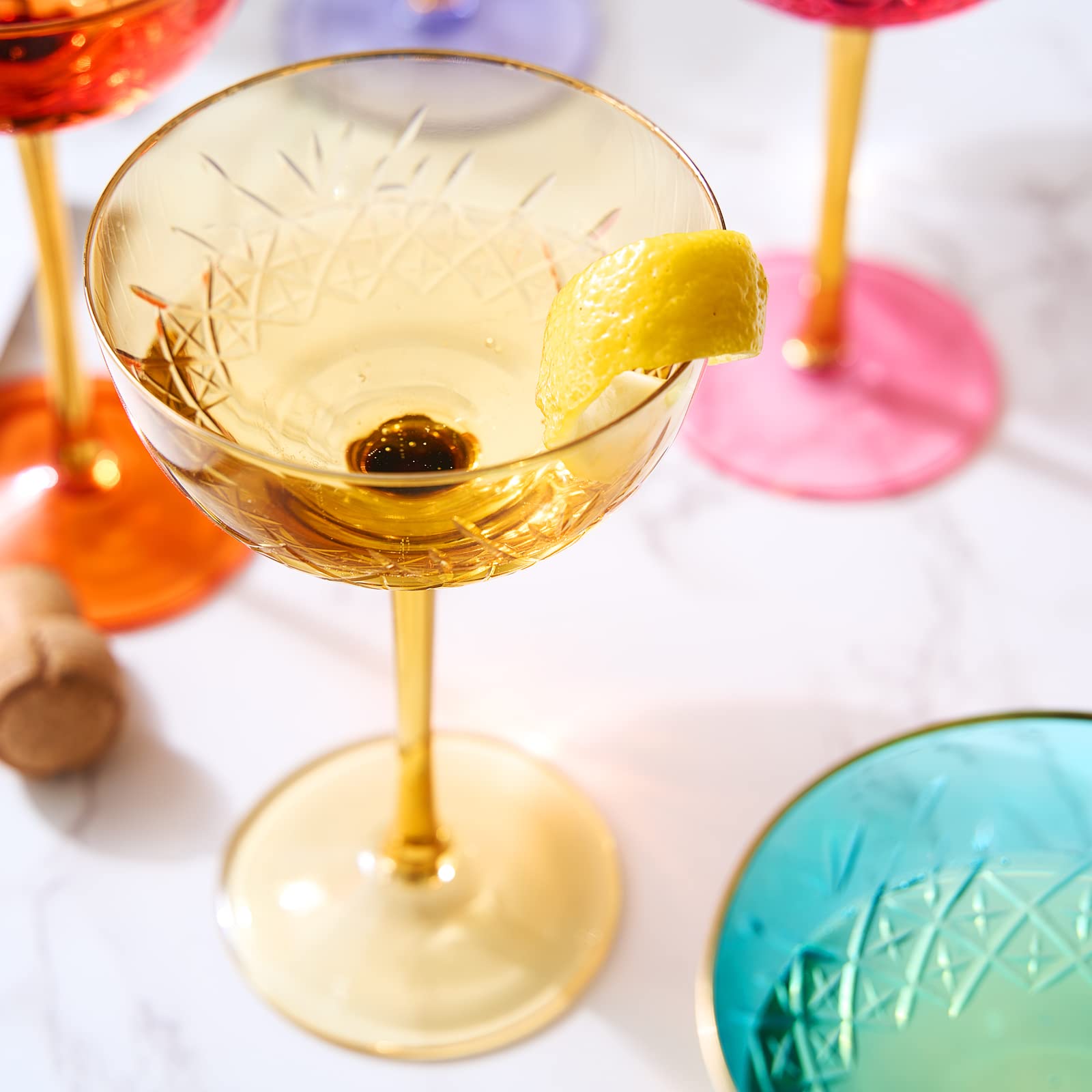 The Wine Savant gold-rim colored coupe glasses elevate table decor for special occasions.