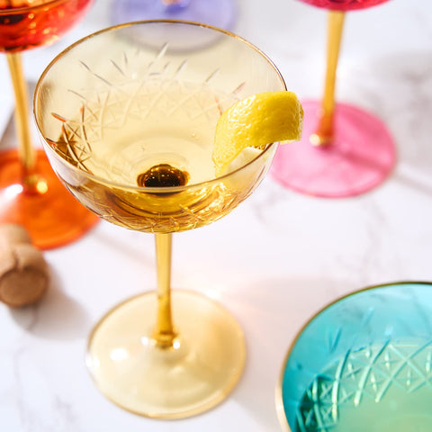 The Wine Savant gold-rim colored coupe glasses elevate table decor for special occasions.