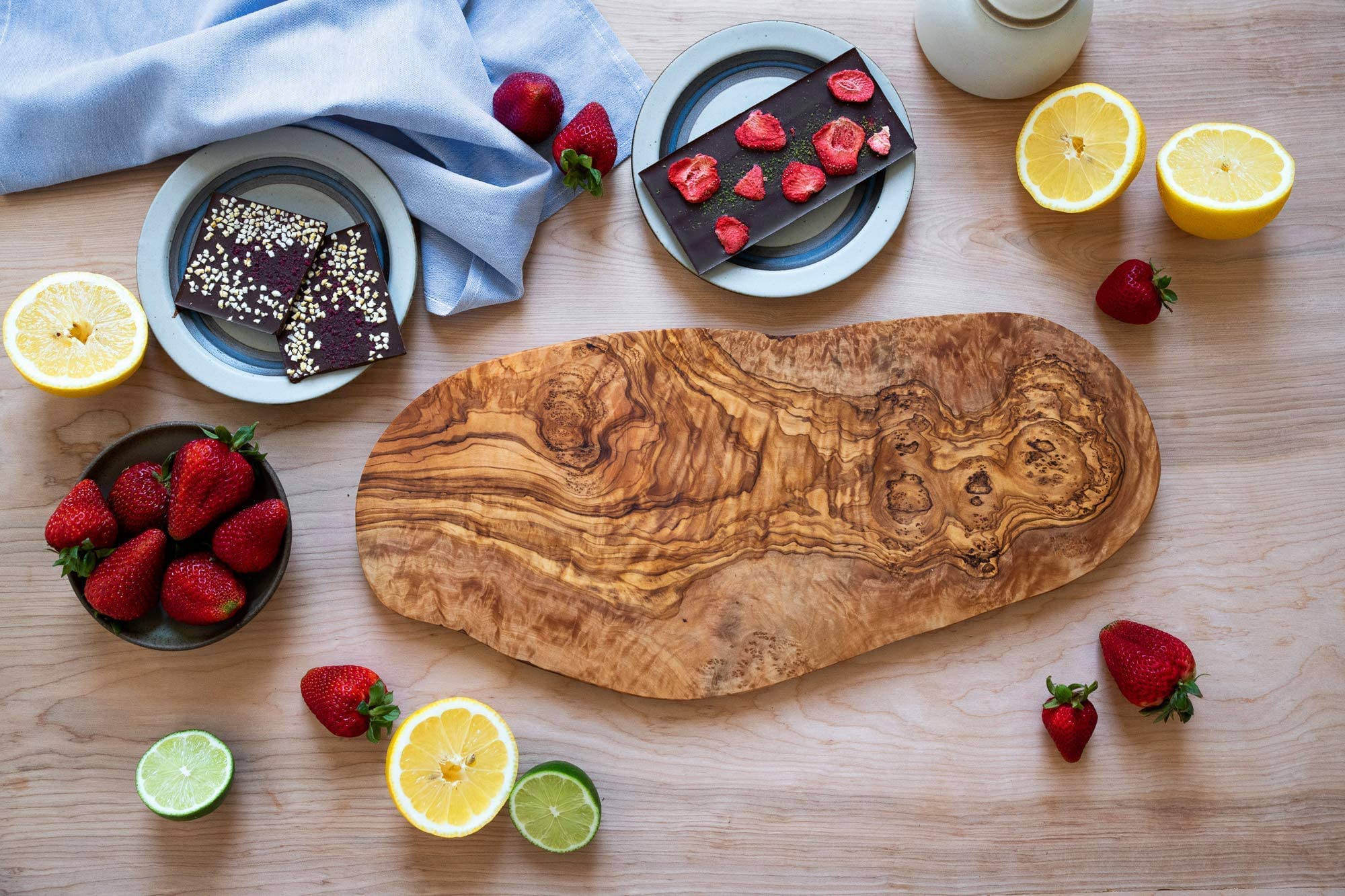 Thirteen Chefs olive wood cutting board cheese service highlights natural color and texture.