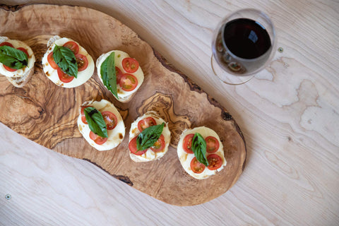 Thirteen Chefs olive wood cutting board rustic edge look adds warm charm.