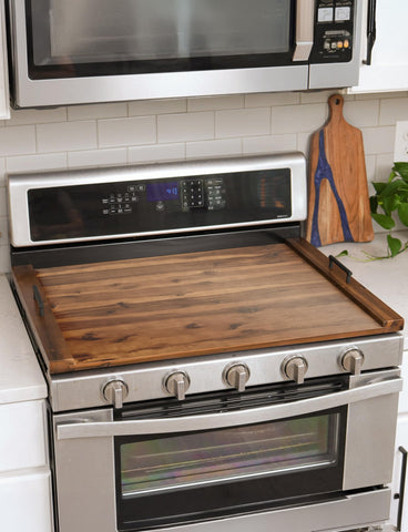Tidita wooden noodle board with built-in handles for easy transport of items.