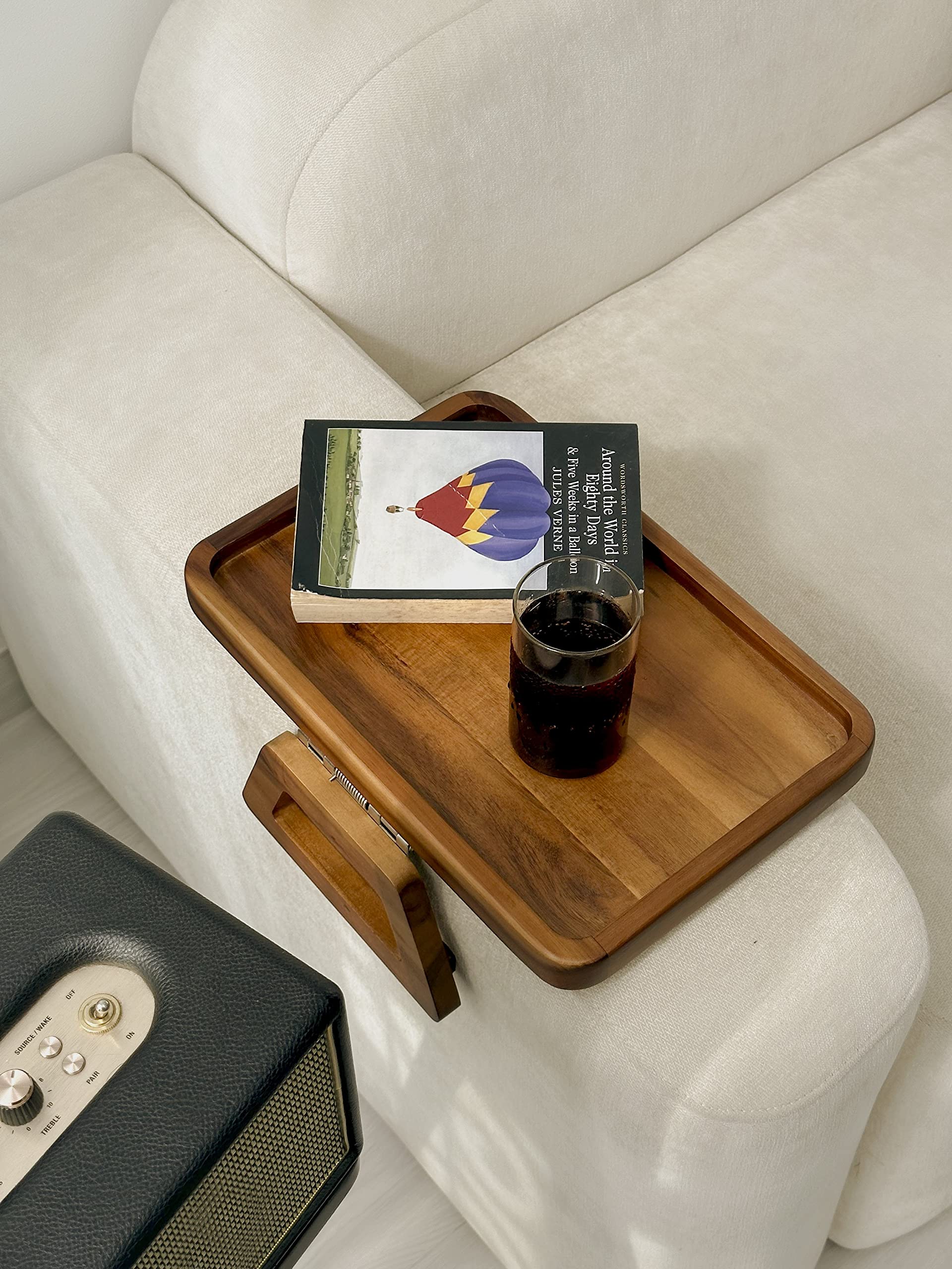 Tinamo acacia compact tray stores discreetly behind sofa.