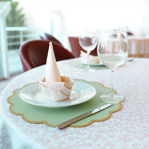 Stacked Tinlade sage green placemats ready for use