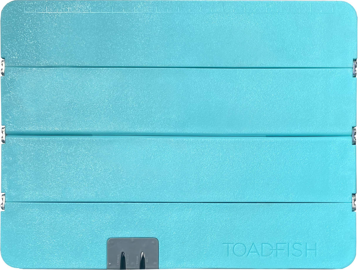 Toadfish Stowaway Cutting Board folded for compact countertop storage.