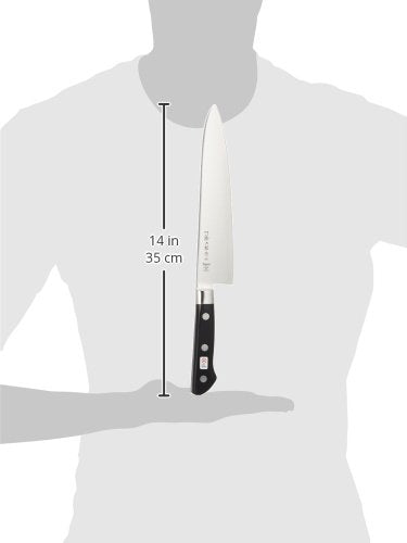 Tojiro 8.2-inch knife in use cutting vegetables for smooth results.
