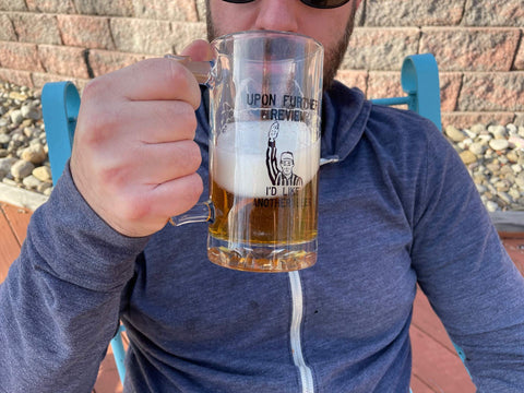 Toothsome Studios Upon Further Review mug side view, sturdy thumb grip for everyday sipping.