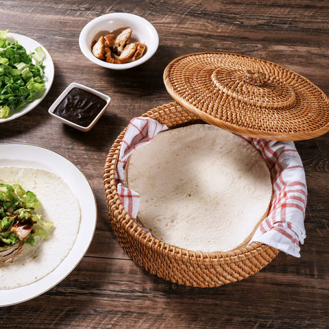 Tortillada tortillas inside the warmer basket staying soft and ready to serve.