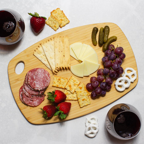 Totally Bamboo Greelite cutting board serving cheese and snacks with style.