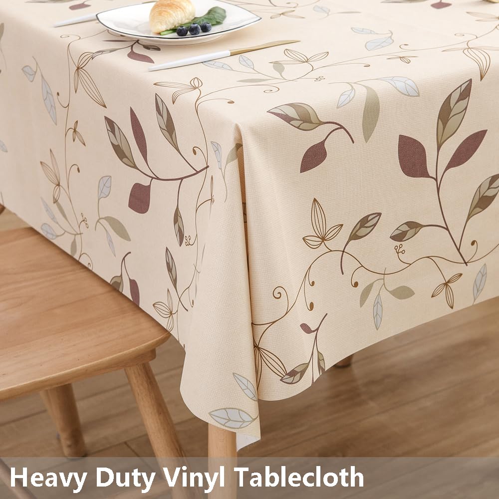 TruDelve beige vinyl tablecloth drapes over a table for elegant dining.