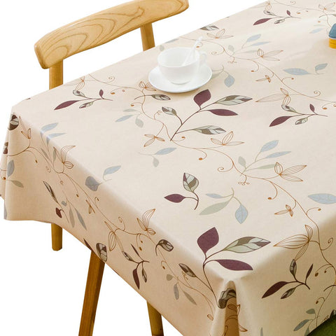 TruDelve beige heavy-duty vinyl tablecloth on a rectangle table, waterproof protection.