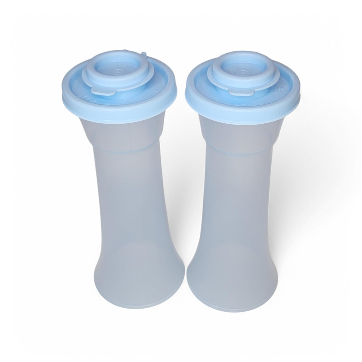 Tupperware large hourglass salt and pepper shakers in sheer ice blue with airtight seals.