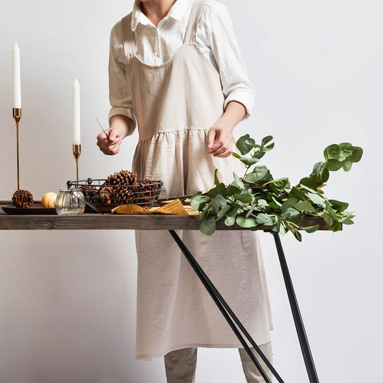 Uaussi pinafore style apron protects clothing during busy tasks.