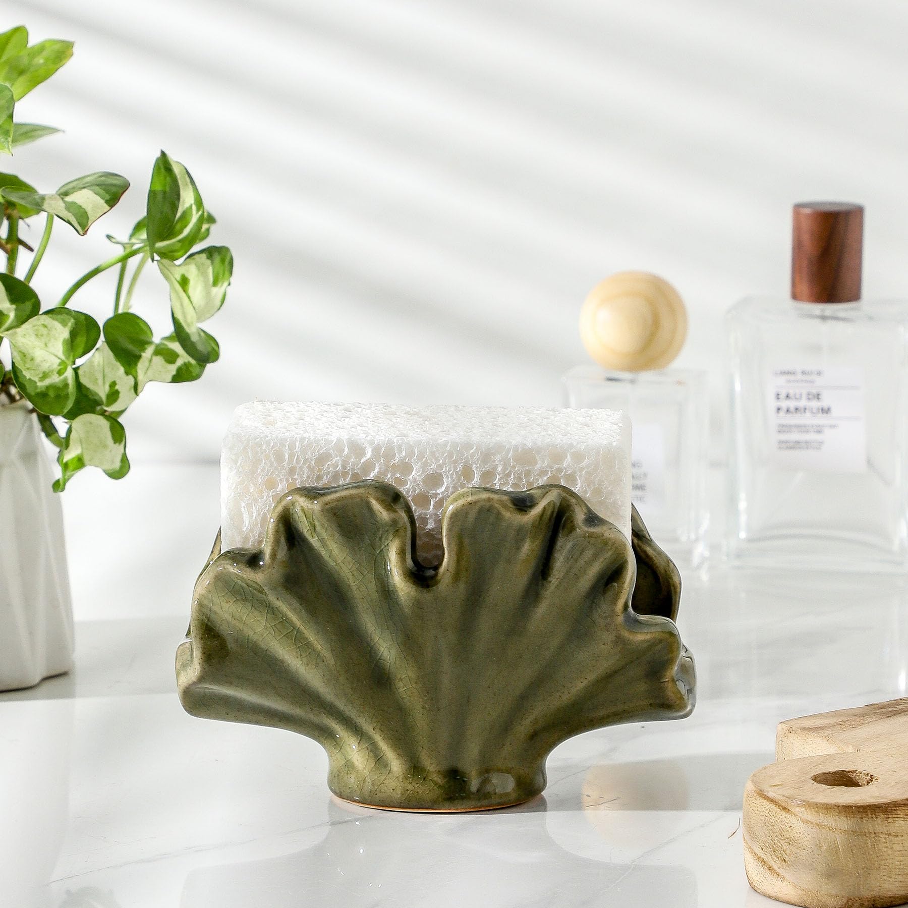 Uiddo green farmhouse sink organizer keeps scrubbers within reach.