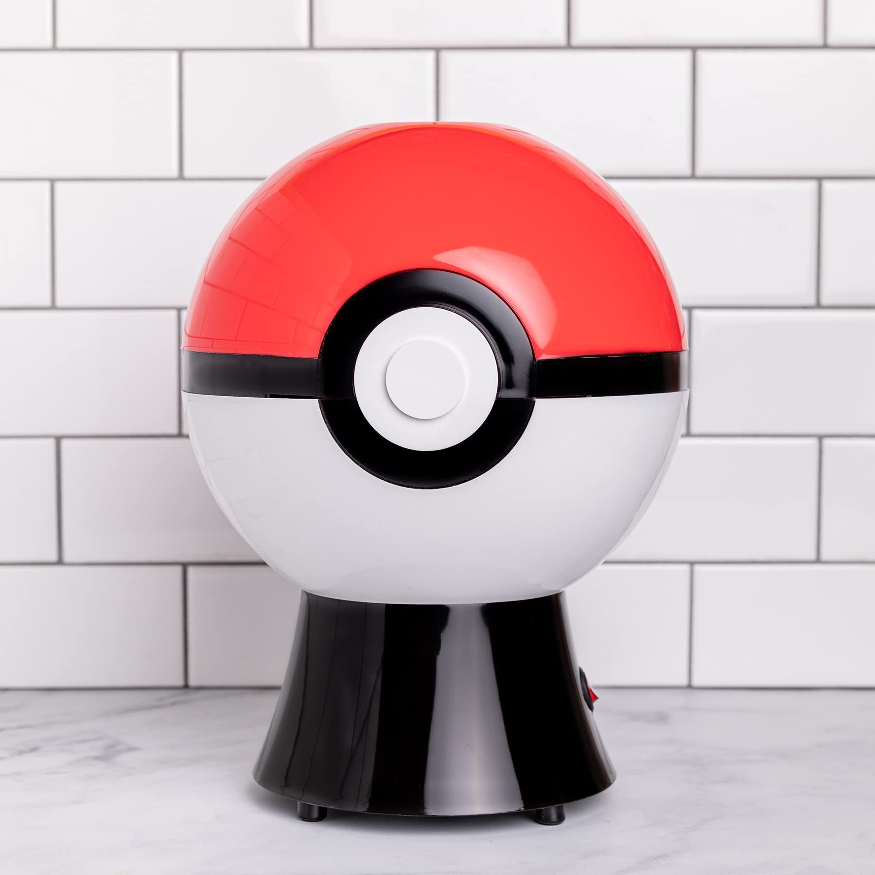 Uncanny Brands Poké Ball popcorn maker easy-clean design and parts.