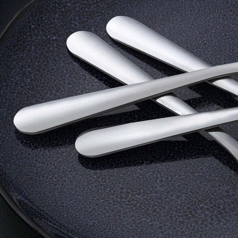 Unokit spoons on dining table showing versatility for soups and desserts
