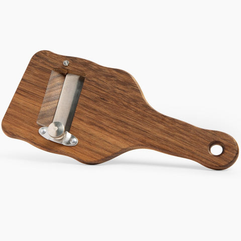 Urbani Truffles dessert-ready slicer shaves chocolate for refined presentation.